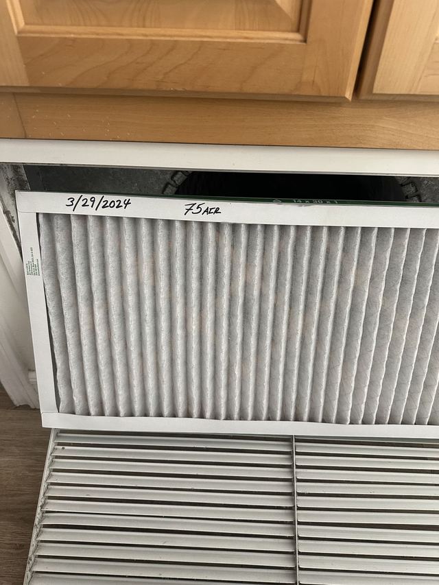Air filter in a return air grille during a heating service visit