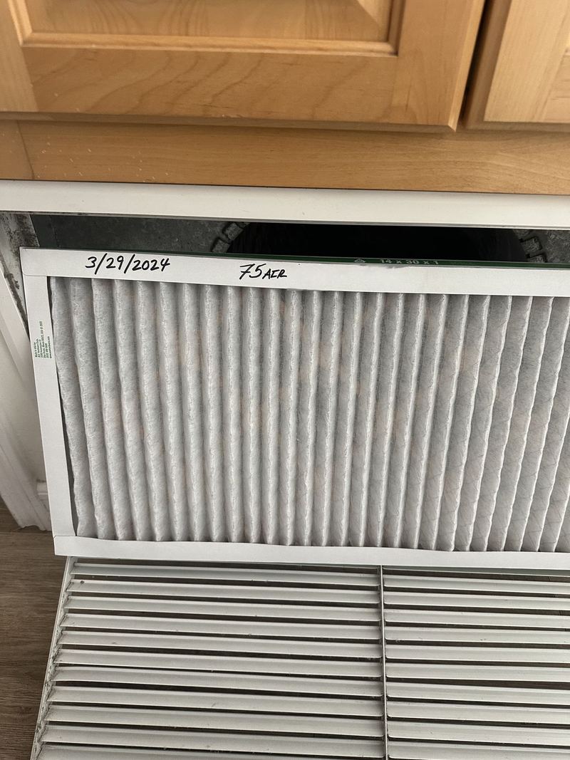 Air filter in a return air grille during a heating service visit