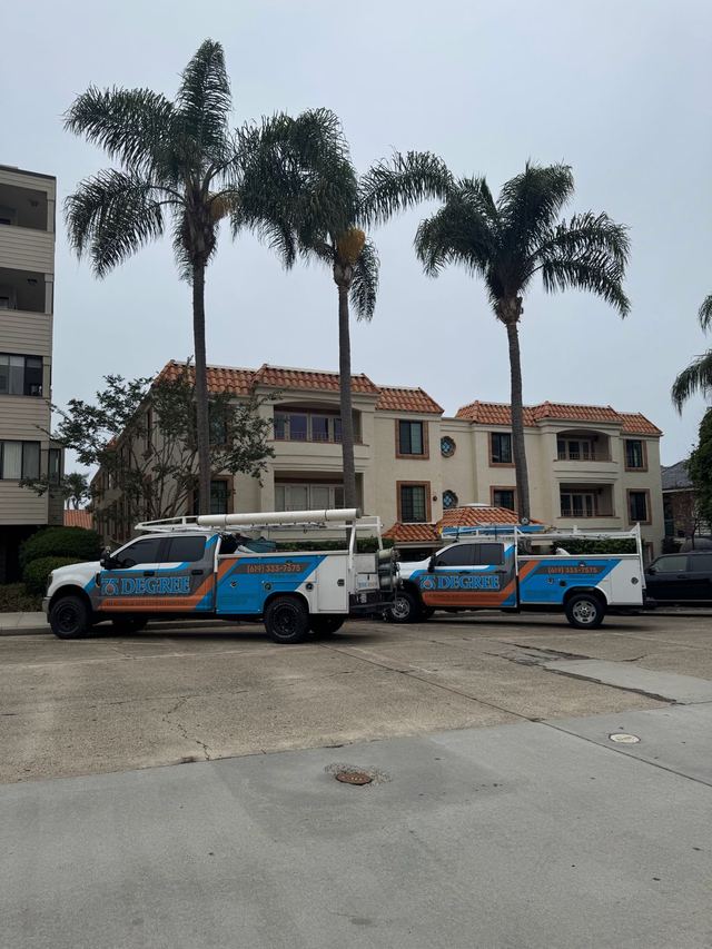 Two 75 Degree service trucks in front of a San Diego building